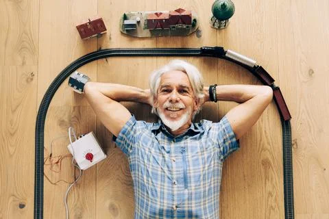 Senior Man Playing With Model Train Stock Photos