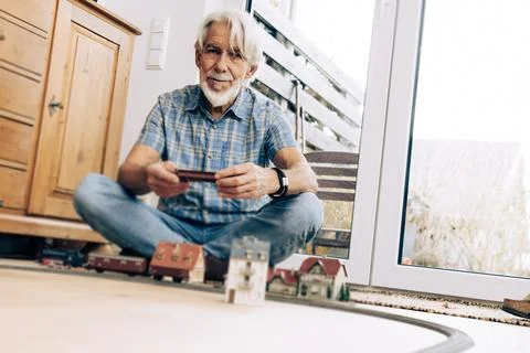 Senior Man Playing With Model Train Stock Photos