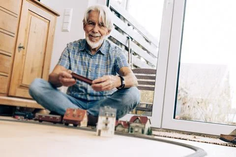 Senior Man Playing With Model Train Stock Photos