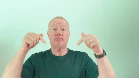 Senior man pointing down to subscribe or leave a comment on social media Stock Footage 299895450