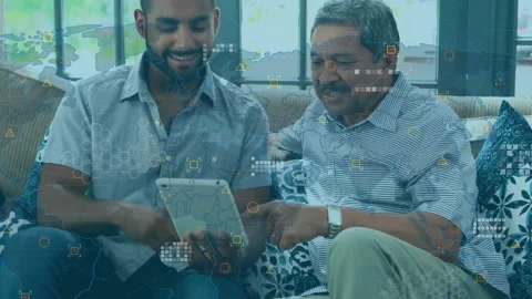Senior man pointing tablet screen and activating data overlays while son Stock Footage 313569917