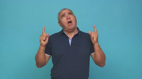 Senior man pointing upside with opened mouth Stock Footage 144217672