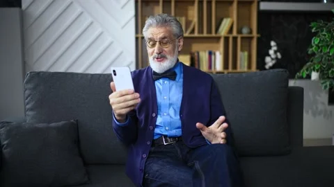 Senior man portrait talking to the camera nodding his head in a shirt with a tie Stock Footage 236167047