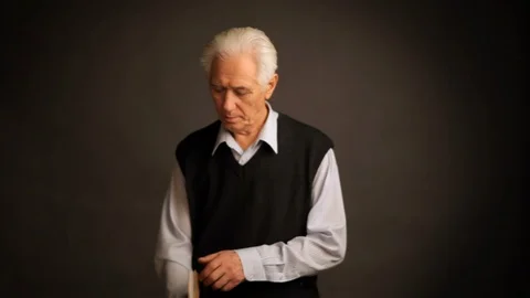 Senior man poses with a book Stock Footage 98719935