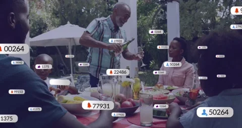 Senior man pouring drink while serving family, sparking tech badges multiplying Stock Footage 331269642