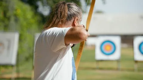 Senior man practicing archery aiming for targets and goals Stock Photos
