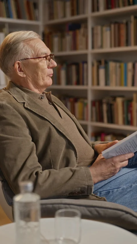 Senior Man Presenting Book during Educational Lecture in Library Stock Footage 338045869