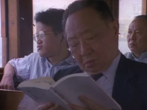 Senior man reading book while travelling on ferry Video stock 79879096