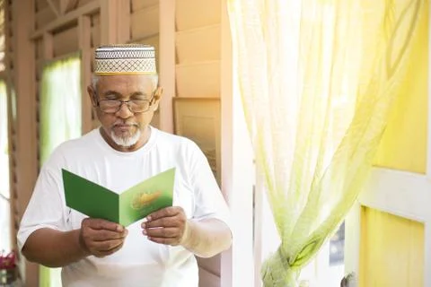 Senior man reading an Eid greeting card Stock Photos
