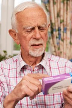 Senior Man Reading Instructions On Medication Stock Photos