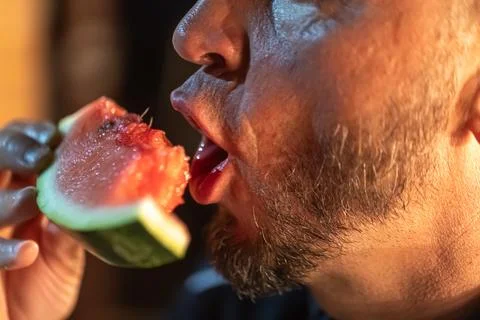 Senior man ready to bite into a watermelon. Stock Photos