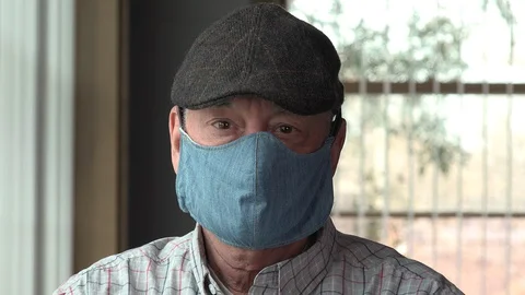 Senior man removing protective face mask Stock Footage 128102634