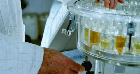 Senior man right-hand reaching and picking vial from carousel, adjusting knob, Stockbeeldmateriaal 334040422