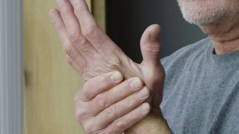 Senior man rubbing his wrist in pain Stock Footage
