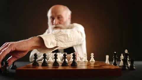 Senior Man Setting Black Chess Pieces on Board Stock Footage 263479485
