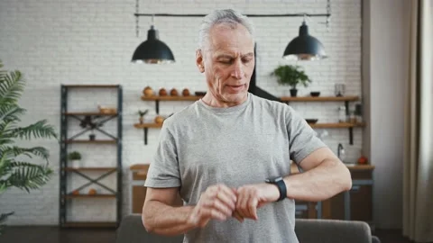 Senior man setting timer on smartwatch and holding his breath during breathing Stock Footage 146711226