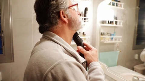 Senior man shaving his beard Stock Footage 102729531