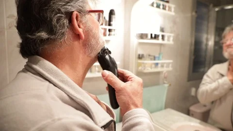 Senior man shaving his beard Stock Footage 102729541