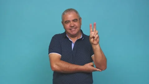 Senior man showing number two with fingers Stock Footage 144217778