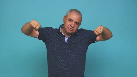 Senior man showing thumb down and expressing dislike Stock Footage 144217834