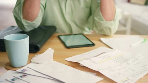 A senior man sits and does his bills with slight frustration Stock Footage 34011423