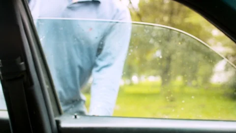 Senior man sitting down in a car Stock Footage 114572074