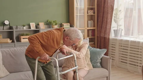 Senior Man Sitting Down Using Walker Stock Footage 162823241