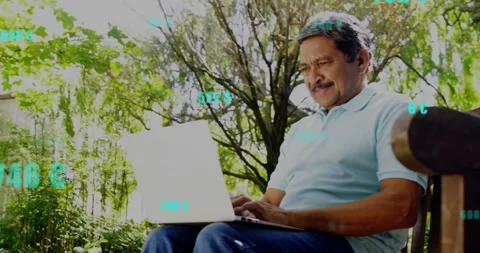 Senior man sitting garden bench typing on laptop causing cyan data overlays Stock Footage 331045290