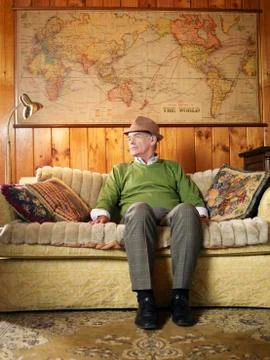 Senior Man Sitting On Sofa Stock Photos