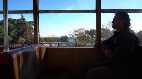 Senior man sitting on train and looking out through window. Stock Footage 87962307