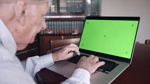 Senior man slowly typing on computer keyboard with green screen chroma key Stock Footage 170463811