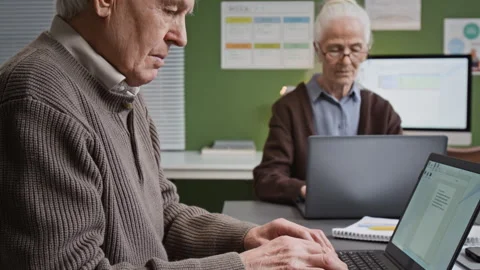 Senior Man Slowly Typing in Computer Literacy Class for Seniors Stock Footage 333704119