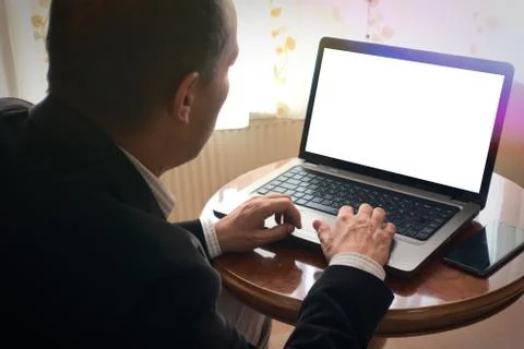 Senior man in smart clothes using laptop on table at home blank screen copysp Stock Photos