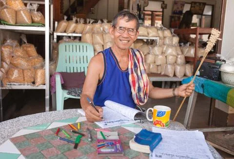 Senior Man smiling and write a book relax time at home Stock Photos