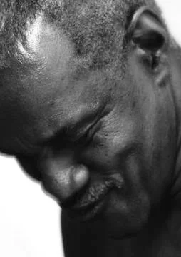 Senior man smiling, head down, close-up. 写真素材