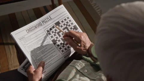 Senior Man Solving Crossword Puzzle for Cognitive Health Stock Footage 341398273