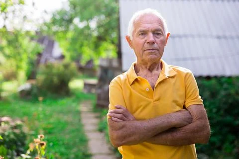 Senior man standing in backyard Stock Photos