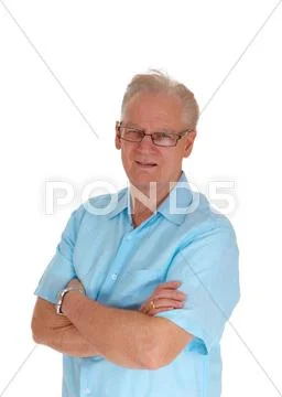 Senior man standing with his arms crossed. Stock Photos