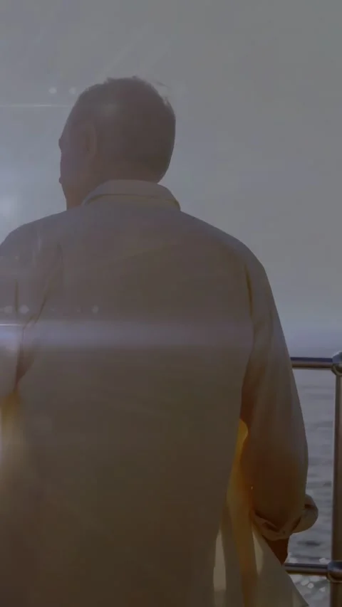 Senior man standing at railing, sun flare causing tech overlay shimmering over Stock Footage 332317517