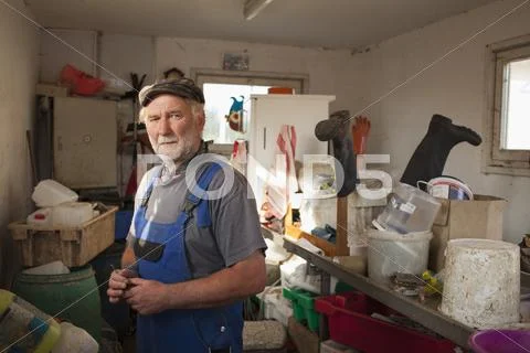 Senior Man Standing In Storage Room