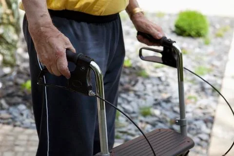 A senior man standing with a walker, midsection, outdoors Stock Photos