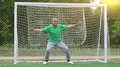 Senior man stands in football goal HD Footage