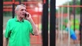 Senior man stands near sports ground and speaks on cell phone HD Footage