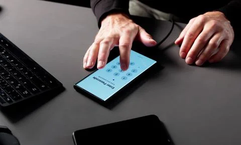 Senior Man Stealing Data From Smartphone Using Hacking Software Anonymously. Stock Photos
