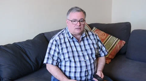 Senior Man Struggles with Remotes Stock Footage 49503235