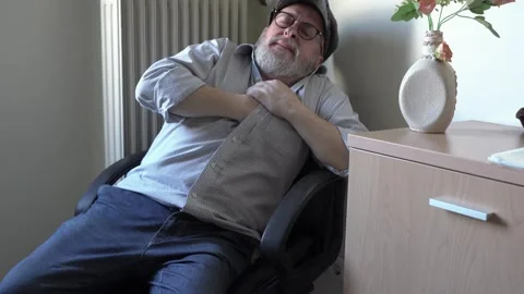 Senior man suffering from heart attack at home, Man clutching his chest Stock Footage 338130686