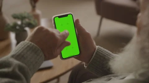 Senior Man Swipe and Push Button on Bottom of Green Screen Smartphone 스톡 동영상 241086297