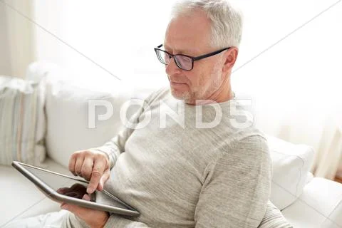 Senior man with tablet pc at home Stock Photos