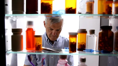 Senior man taking pills Stock Footage 32710929