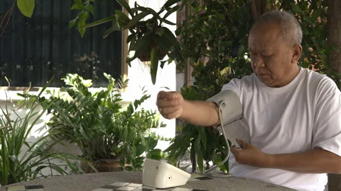 Senior man taking self-measurement of blood pressure Stock Footage 253147249